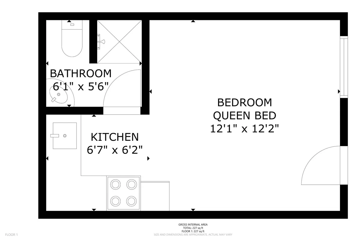 An interior shot of a suite showcases a well-equipped kitchenette, queen bed, and adjacent bathroom, all in a cozy, recently updated space. The layout is practical, emphasizing comfort and flexibility for preparing meals and relaxing after a day of exploration.