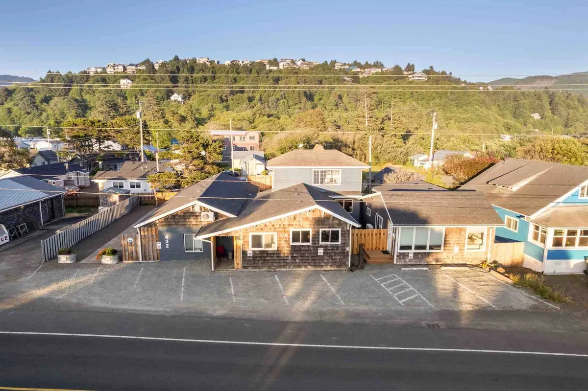 A broader exterior view displays the charming architectural styles of the buildings, abundant greenery, and easy access to nearby shops and gathering spots. The scene is relaxed, reflecting a welcoming neighborhood atmosphere.