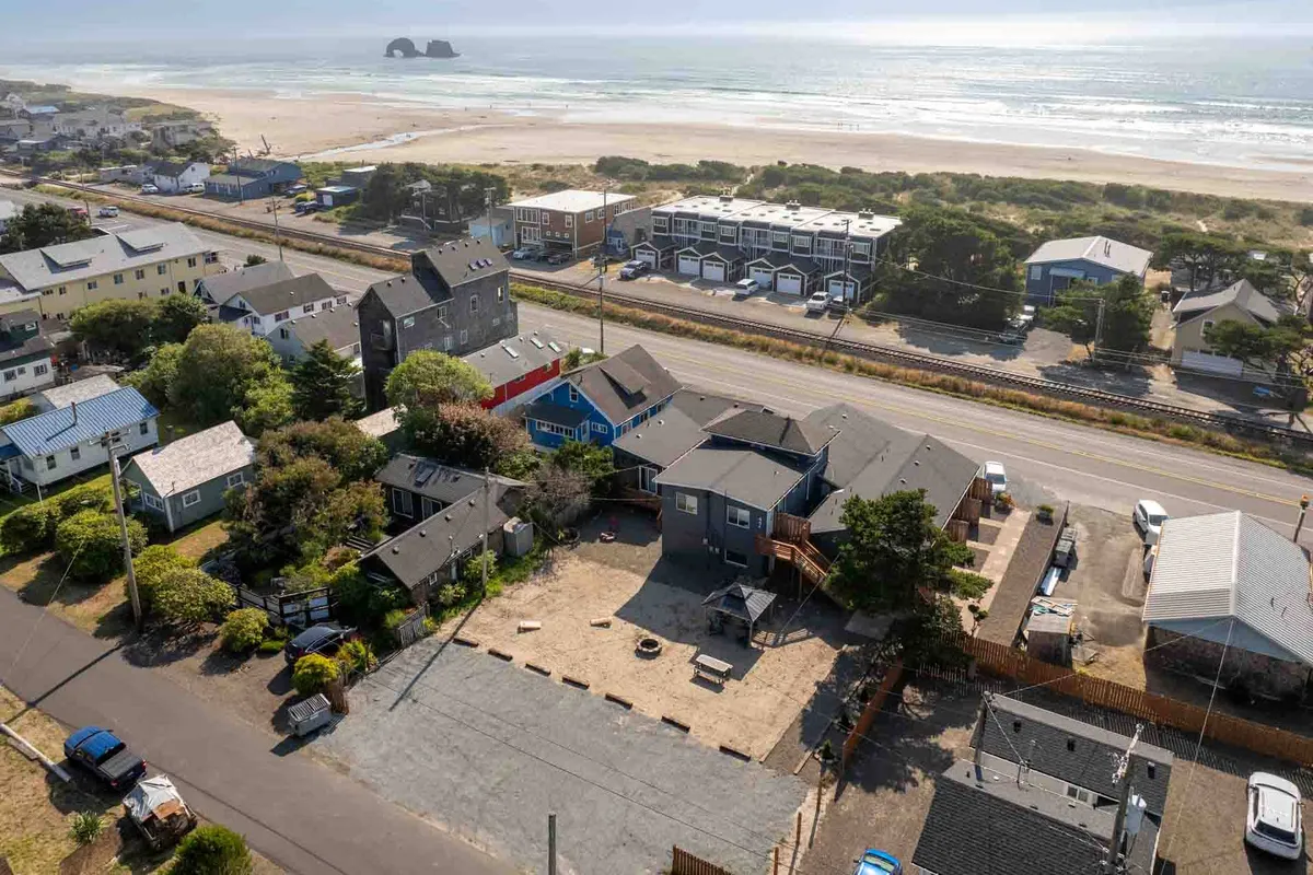 A scenic view of the beachfront with pathways leading from neighborhood houses to the sand, play areas, and gathering spots. The inviting layout encourages beach walks and easy community access.